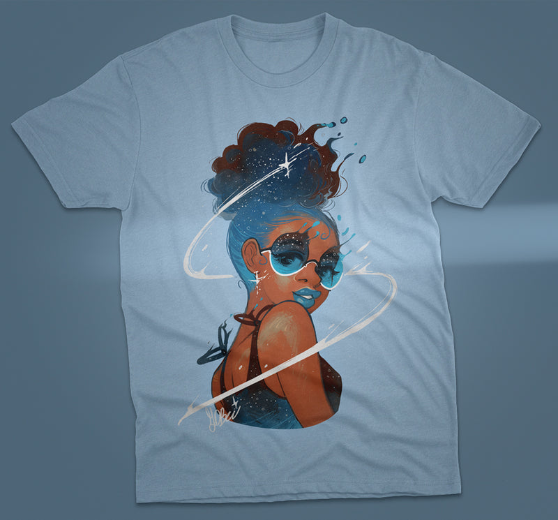 Light blue GDBee Art T-shirt featuring a stylish woman with curly hair, sunglasses, and cosmic swirl design