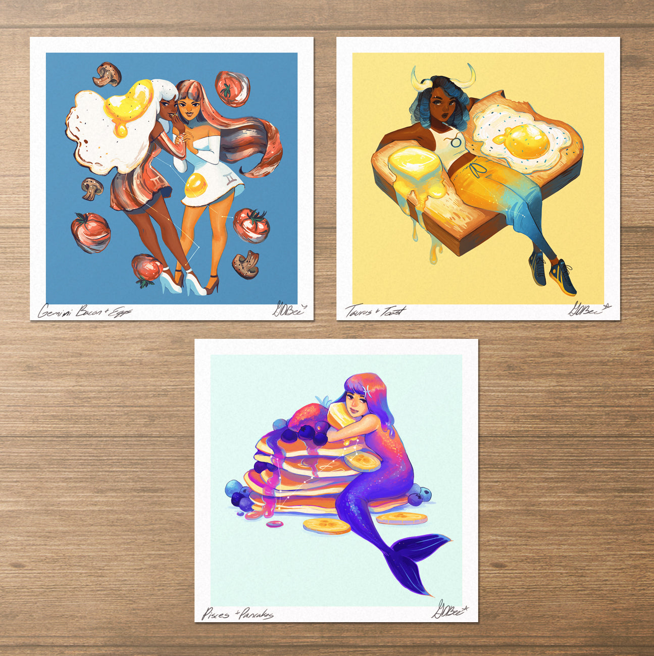 GDBee zodiac art prints featuring Gemini with eggs, Taurus with toast, and Pisces with pancakes.